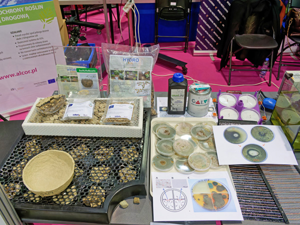 A display table with various dishes, containers, packaged products and printed instructions